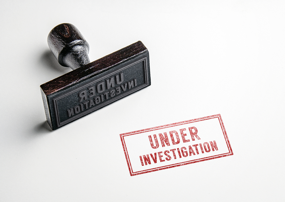 A red stamp that reads, "under investigation."