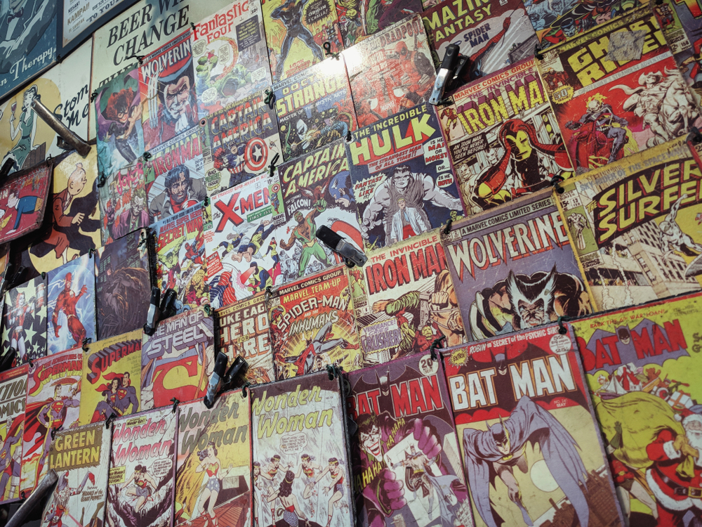 A photo of comic books arranged on a shelf display.