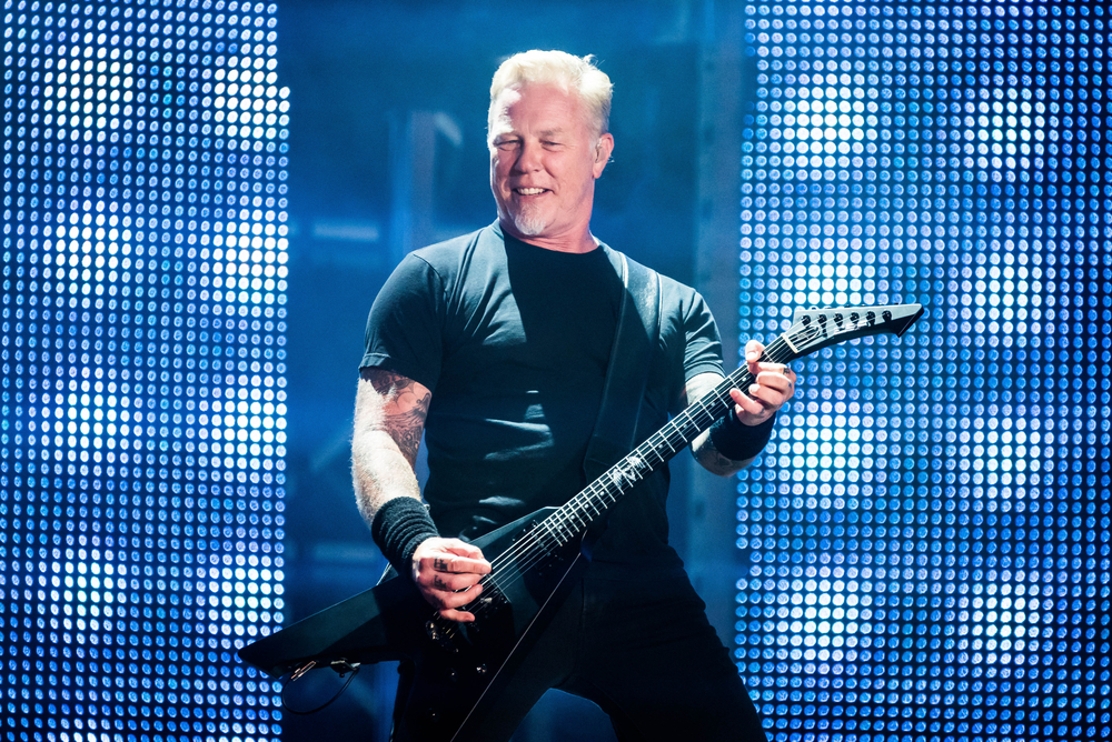 A photo of James Hetfield, lead singer of Metallica, playing guitar on stage.